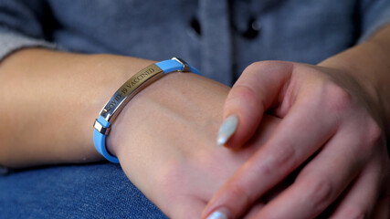 Woman hand with vaccined bracelet or label after injection in hospital. Unrecognizable female person after quarantine. Prevention precaution to preserve health. Safety and coronavirus pandemic concept