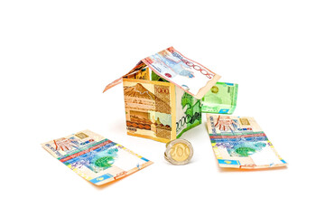 Banknotes and coins of the Republic of Kazakhstan isolated on a white background.