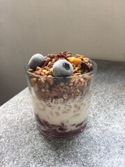 granola with yogurt and blueberries in a glass