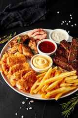 plate of snacks on black textured background