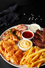 plate of snacks on black textured background