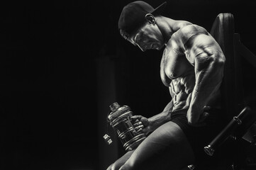 Bodybuilder drinking water after fitness workout