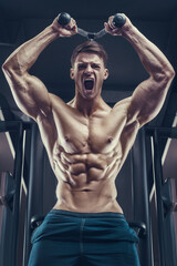 Fototapeta na wymiar Bodybuilder strong man pumping up triceps muscles