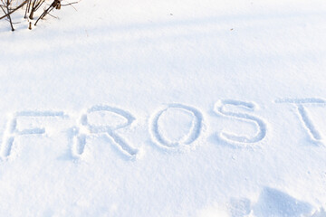 inscription on pure white snow on a frosty winter sunny day. close-up. russia