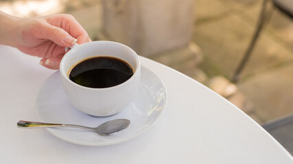 a cup of coffee on white table with work break time, food concept. Close up of a glass of hot espresso mix Soft drink with copy space