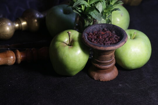 bowl with hookah tobacco. shiisha with fruits on black background.