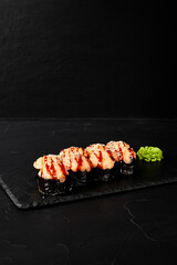 rolls on a black board on a dark textured background