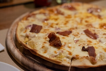 Close up of a piece of Pizza on the table.