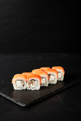 rolls on a black board on a dark textured background