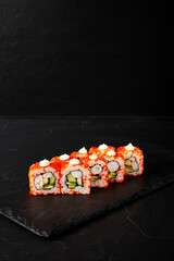 rolls on a black board on a dark textured background