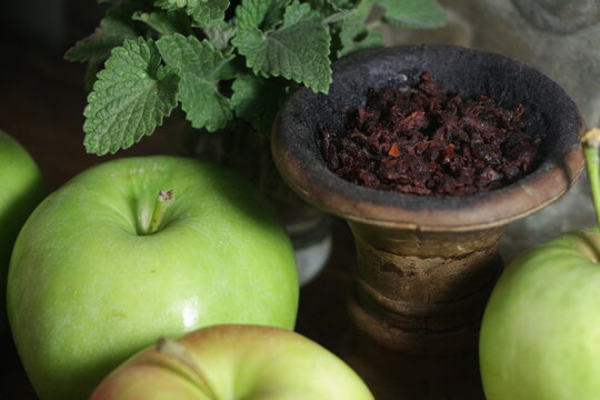 bowl with hookah tobacco. shiisha with fruits on black background.