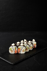 rolls on a black board on a dark textured background