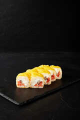 rolls on a black board on a dark textured background