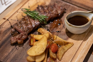 Medium rare meat on plate with sauce and fries