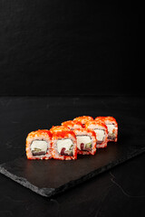 rolls on a black board on a dark textured background