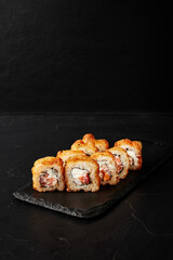 rolls on a black board on a dark textured background