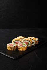 rolls on a black board on a dark textured background