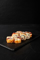 rolls on a black board on a dark textured background