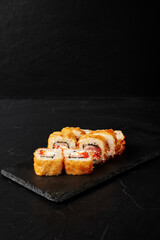 rolls on a black board on a dark textured background