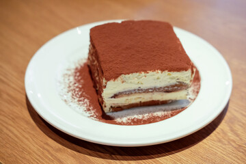 Tiramisu served on plate in the restaurant
