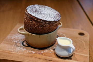 Chocolate souffle served on wooden plate