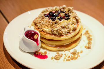 Blueberry pancake with sauce, crumble. served on plate