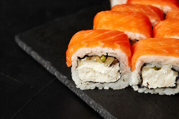 rolls on a black board on a dark textured background