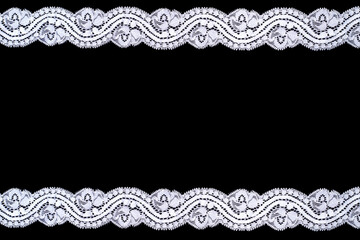Lace trim ribbon over black background