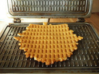 Cooking waffles at home. Culinary background. Homemade dessert. Waffle maker