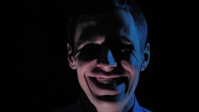 Man in the dark with creepy smile