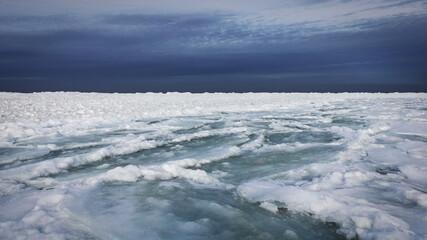Snowy glaciers on a sunny winter day by the sea.