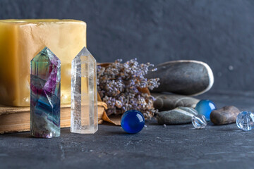 Magic still life with fluorite, quartz crystal and pink candle. Magic rocks for mystic ritual,...
