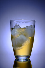 Transparent glass with drink and ice, advertising photography, selective focus