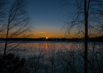 Sunset at the frozen lake Älgsjön in Värmland / Sweden.