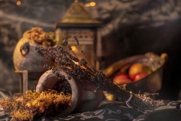 Still life of different jars with lavender flowers and apples in soft light with focus on the lavender and blurred background.