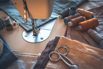 Sewing workspace in a vintage treatment. Sewing machine and accessories.