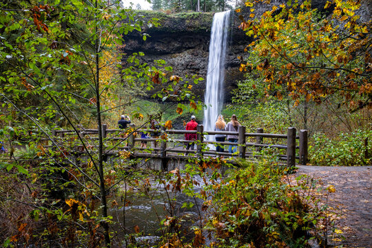People on a bridge over Silver Creek.  They are taking photos of South Falls in Silver Falls State Parn near Silverton Oregon