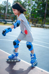A girl with a blue theme is practicing rollerblade having fun. It was a time when she was very...