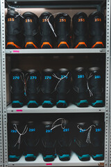 snowboard and ski boots on the shelf in the store, ski equipment