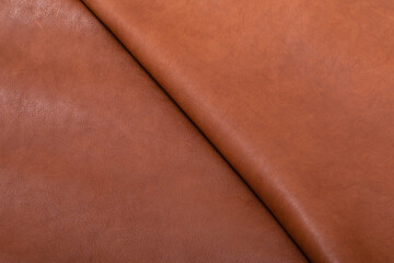 Reddish-colored folded piece of luxury quality cow leather 