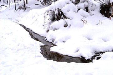a small mountain stream in the snow