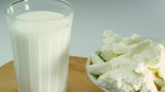 Appetizing cottage cheese with milk in a glass, fresh kefir studio shooting. Yogurt.