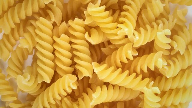 Slowly rotating pile of fusilli pasta background