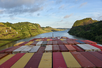 Large container ship transiting Panama Canal, view on the deck loaded with containers. 