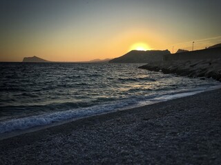 Mediterranean beach with no people at sunset.