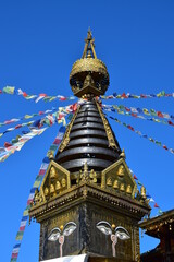 The top of a buddhist temple with Tibetan prayer flags.