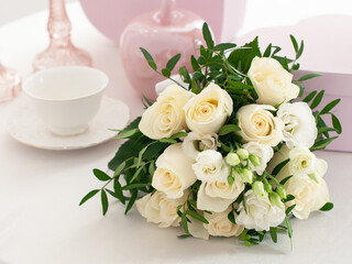 Wedding bouquet of white roses on the bright table