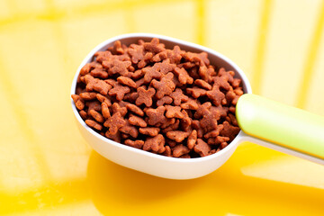 Cat food on yellow background.