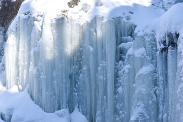 Large icicles around a waterfall