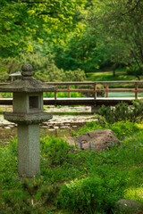 Japanese style park  spring. Stone lanternsin the garden, a traditional decorative element of the Japanese garden.